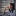 Young woman looking out of an apartment window looking pensive