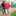 Elderly person walking with a cane on a brick lined path holding onto a younger person