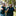 Man and woman pointing and smiling at the camera while outside