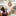 3 young adult women doing a high five in a library 
