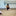 Young child sitting with her head on her knees on the floor  in ballet shoes