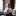 Woman sitting on couch with her head bowed in prayer