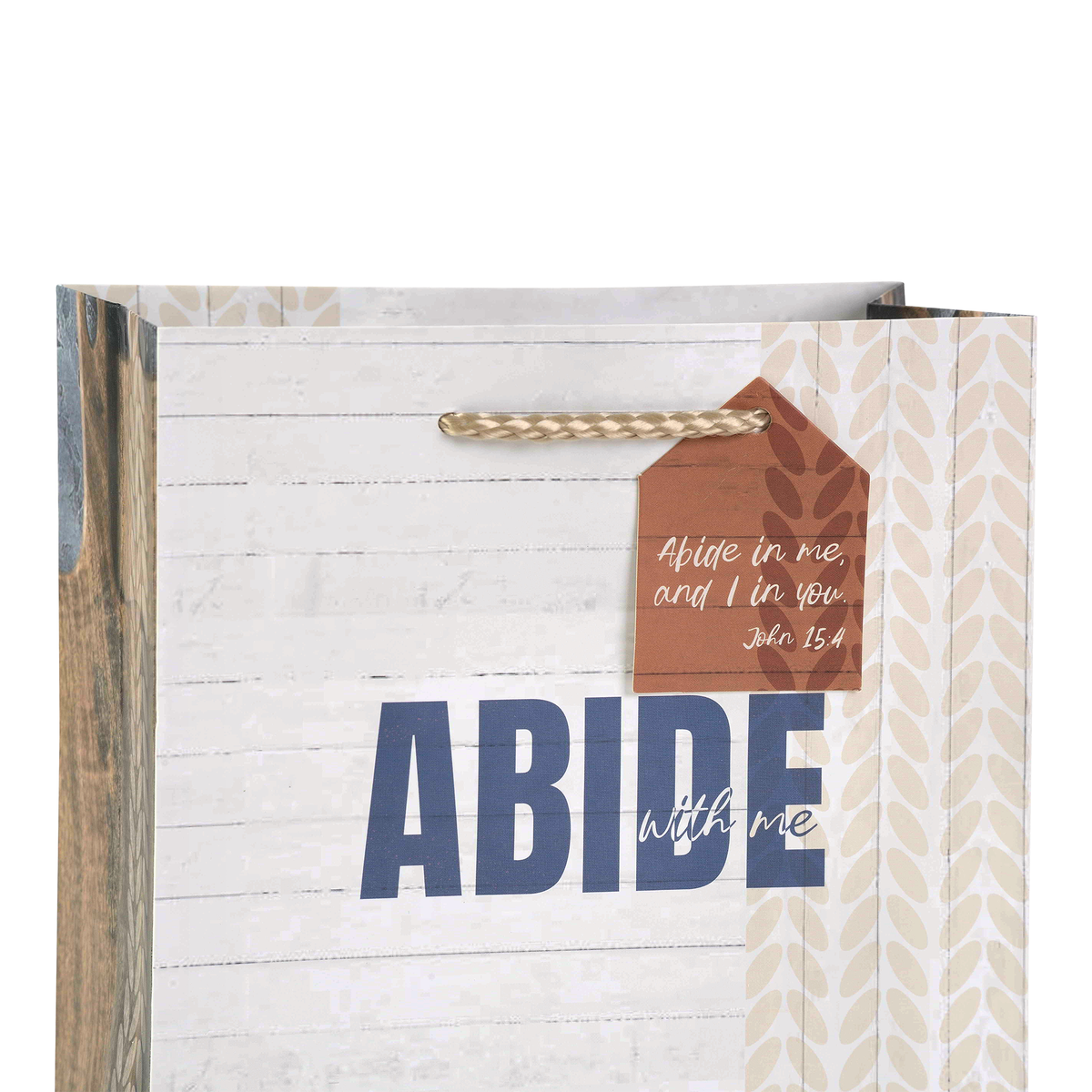 A decorative gift bag with a rustic white wood-plank background, blue 'ABIDE' text, a brown hanging tag with scripture text, and beige patterned side panels by CTA Christ to All and CTA Gifts.