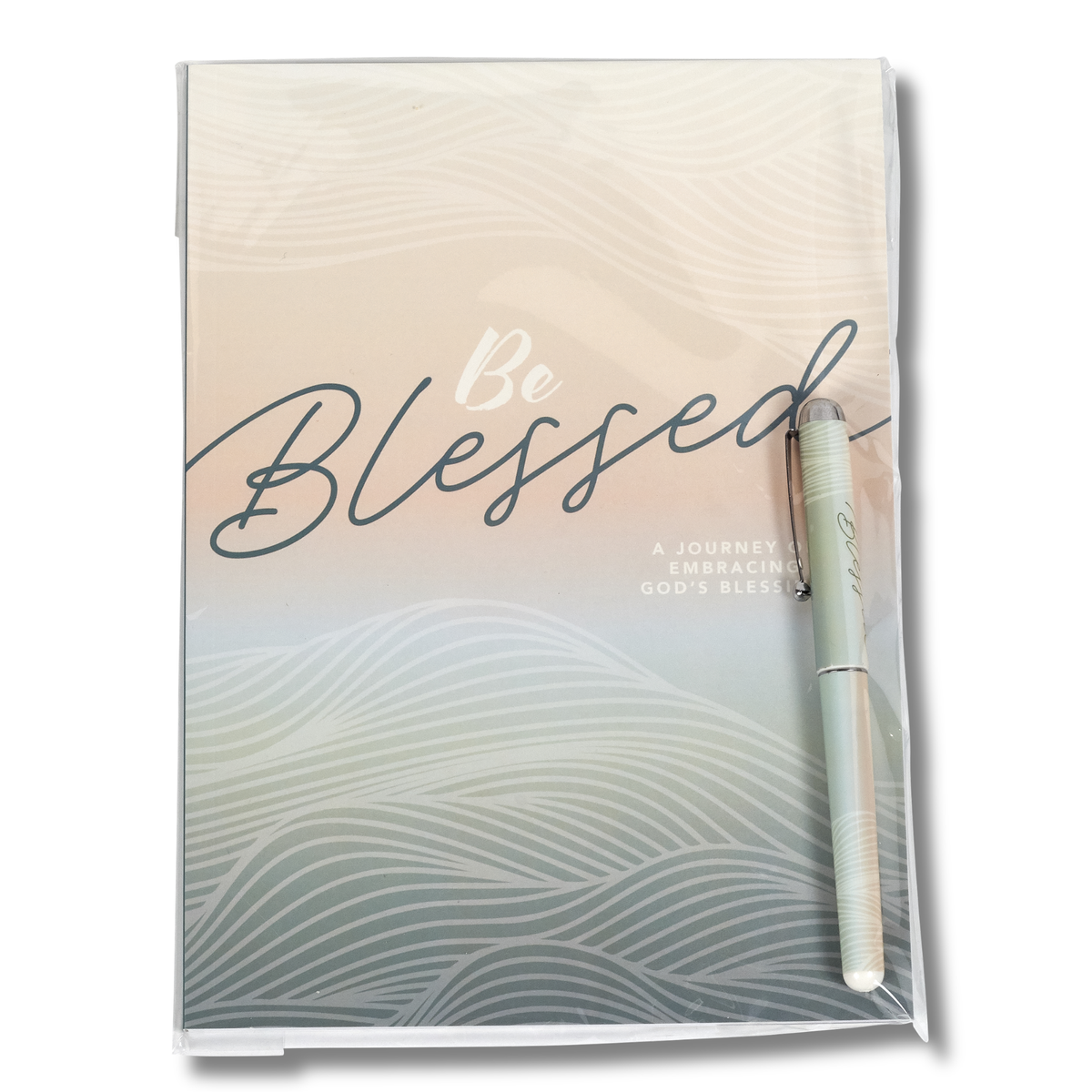 A packaged journal with a clear plastic sleeve, featuring a pastel gradient cover with wavy line patterns and the words 'Be Blessed' in script. A matching light green pen is placed on the cover by CTA Christ to All & CTA Gifts.