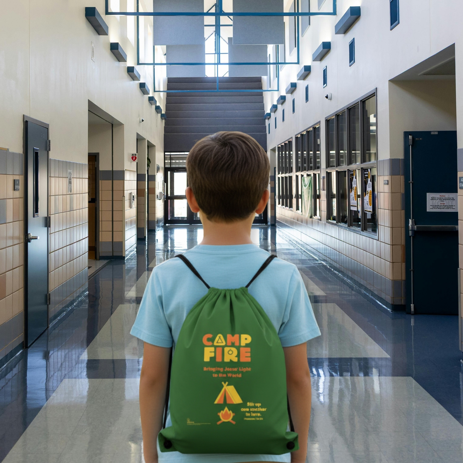 Child with a green 'Camp Fire' backpack walking down a school hallway.