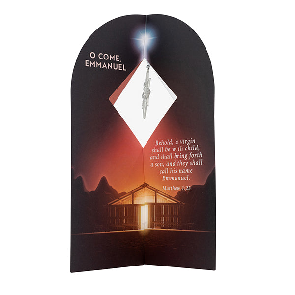 Christian Christmas ornament gift card featuring a silver ornament displayed through a diamond-shaped window above an illuminated stable beneath a bright star. The card includes the text “O Come, Emmanuel” and Matthew 1:23: “Behold, a virgin shall be with child, and shall bring forth a son, and they shall call his name Emmanuel.” Designed as a faith-based Christmas keepsake and gift for church outreach, holiday events, seasonal decorations, and commemorative ornament giving by CTA Christ to All and CTA Gift