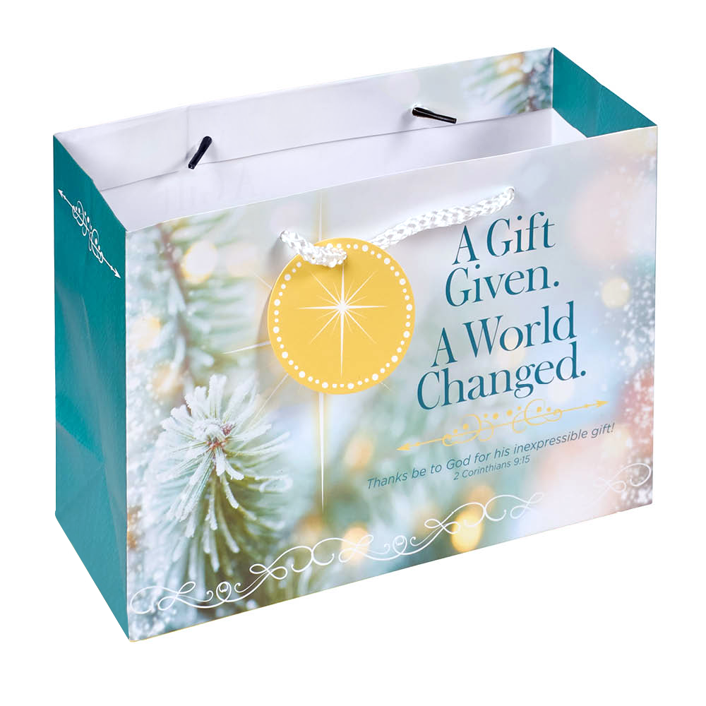 A square gift bag with a festive holiday design, featuring a teal side panel, a white and blue front panel with the text 'A Gift Given. A World Changed by CTA Christ to All and CTA Gifts.