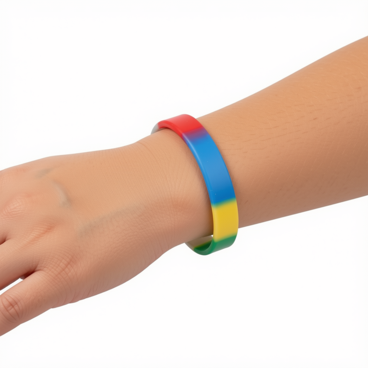 A silicone wristband bracelet with a rainbow color gradient, shown worn on a person's wrist against a plain white background by CTA Christ to All and CTAKids.