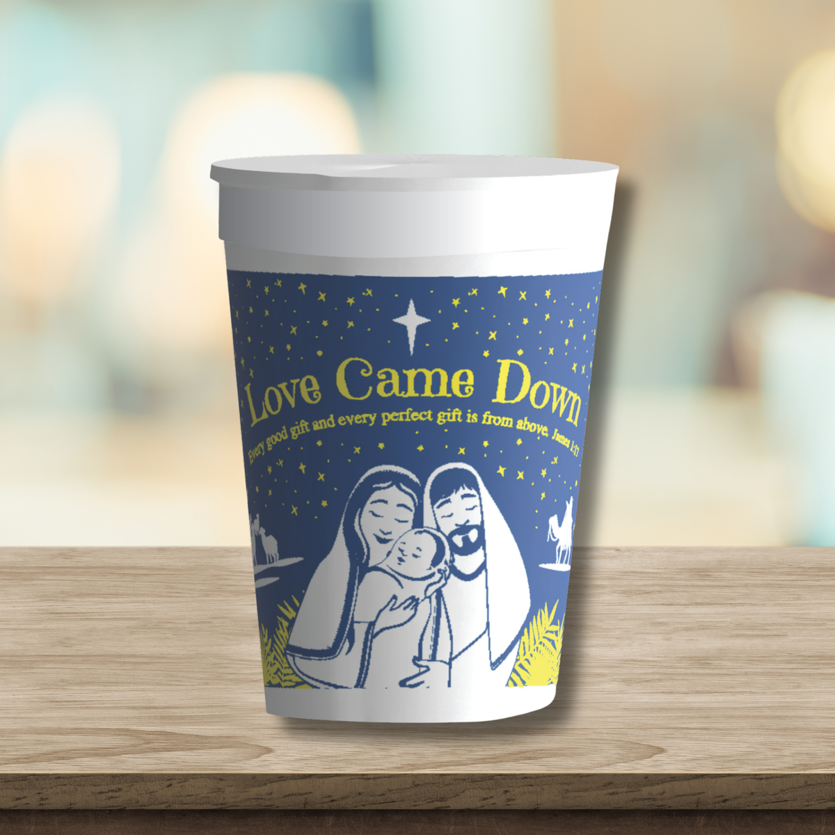 Christmas cup featuring the “Love Came Down” nativity design with Mary, Joseph, and baby Jesus beneath a star-filled night sky. The blue cup with white and gold artwork is displayed upright on a tabletop, showcasing the full wraparound design inspired by James 1:17. Ideal for church Christmas events, holiday gatherings, fellowship meals, refreshments, and seasonal ministry outreach by CTA Christ to All and CTAKids.