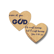 Two heart-shaped wooden coasters with navy blue printed text, one reading 'more of you. GOD' and the other 'He must increase, but I must decrease.' by CTA Christ to All and CTA Gifts.