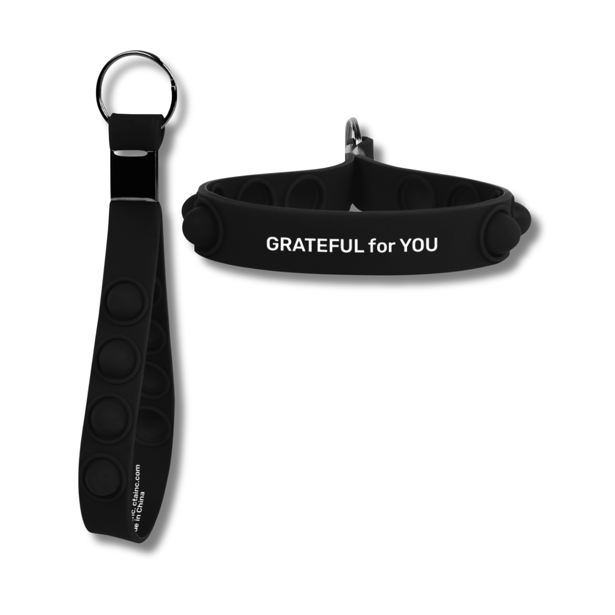 A black silicone fidget keychain shown in two views: one laid flat with a metal key ring and the other shown folded to display the textured circular buttons and the white printed text 'GRATEFUL for YOU' by CTA Christ to All and CTA Gifts.