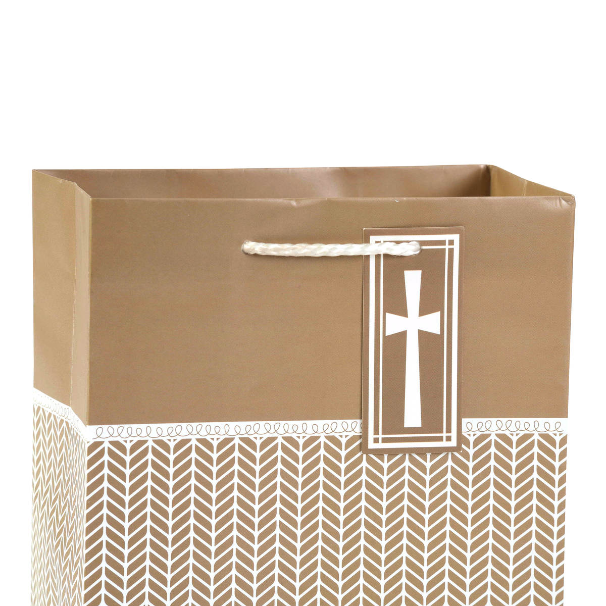A brown paper gift bag with a white rope handle and a hanging tag featuring a white cross, set against a plain white background by CTA Christ to All and CTA Gifts.
