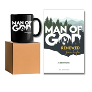 A black ceramic mug with a white 'MAN OF GOD' Bible verse print sits on top of a brown cardboard box, next to a printed devotional card titled 'MAN OF GOD RENEWED for Life' on a white background by CTA Christ to All and CTA Gifts.