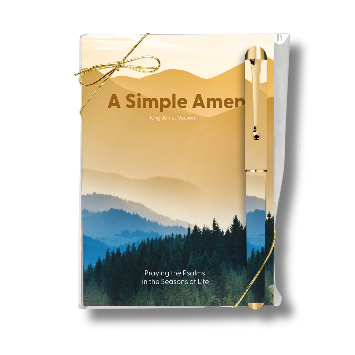 A Simple Amen King James Version prayer book with a gold ribbon tied around it, featuring a scenic mountain and forest cover illustration, and a gold pen attached on the right side, set against a plain white background by CTA Christ to All & CTA Gifts.