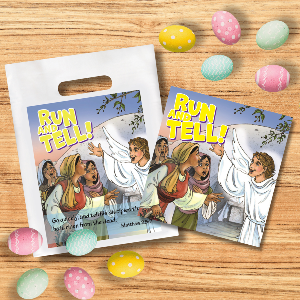 Two printed plastic Easter gift bags with handles are arranged on a wooden surface with colorful decorated Easter eggs around them. The bags feature an illustrated scene with the text 'RUN AND TELL!' and a Bible verse from Matthew 28:10-15 by CTA Christ to All and CTAKids.