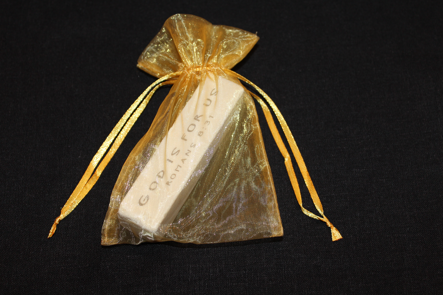 Scripture Stone shown in gold organza gift bag