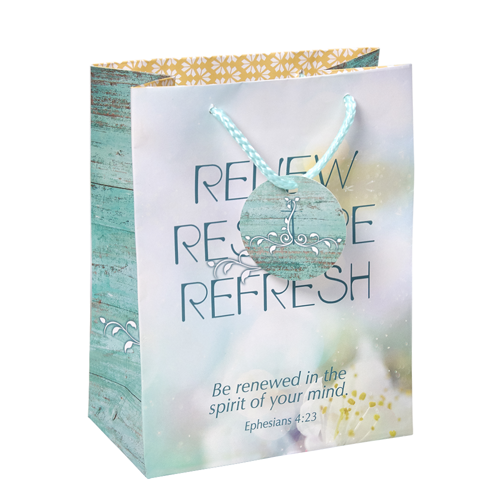 A decorative gift bag with a rustic turquoise wood-grain side panel and a soft pastel front panel. The front reads “RENE RESTORE REFRESH” with ornate teal scrollwork, and smaller text says “Be renewed in the spirit of your mind Ephesians 4:23 by CTA Christ to All & CTA Gifts.
