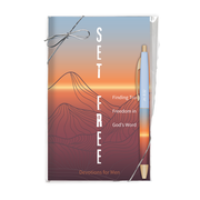 A boxed devotional gift set labeled 'SET FREE' with a mountain-and-sunset illustration, a silver bow on the package, and a blue-and-gold pen tucked inside. The front text reads 'Finding Truth, Freedom in God's Word' and 'Devotions for Men by CTA Christ to All and CTA Gifts.