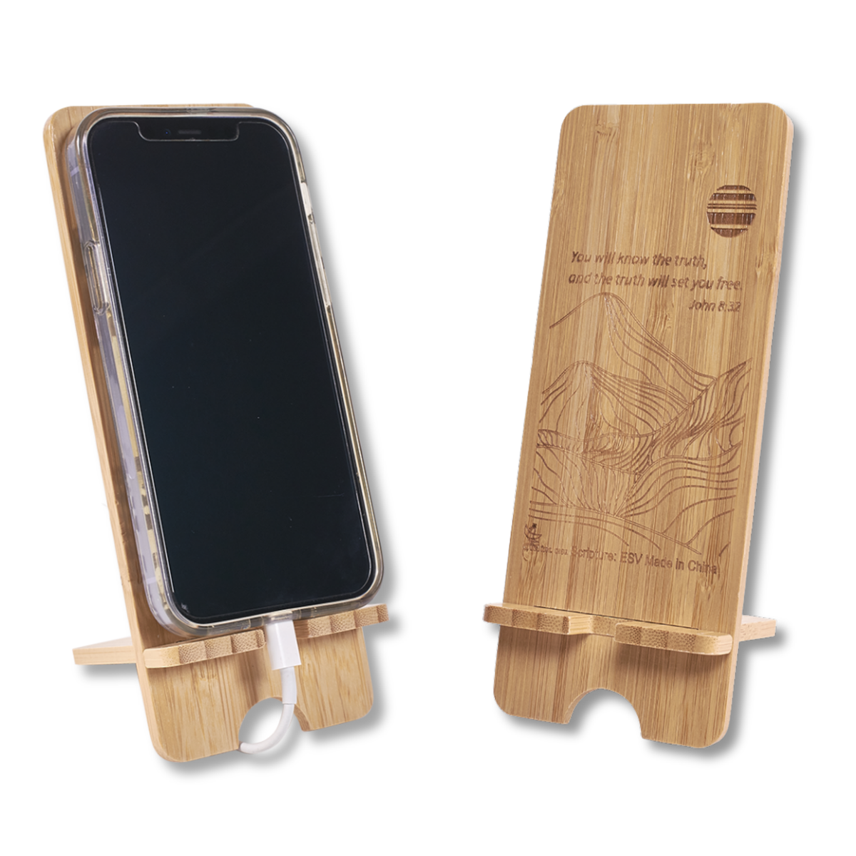 Two bamboo phone stands shown on a white background, one holding a smartphone and the other displaying engraved artwork and text on the back by CTA Christ to All & CTA Gifts.