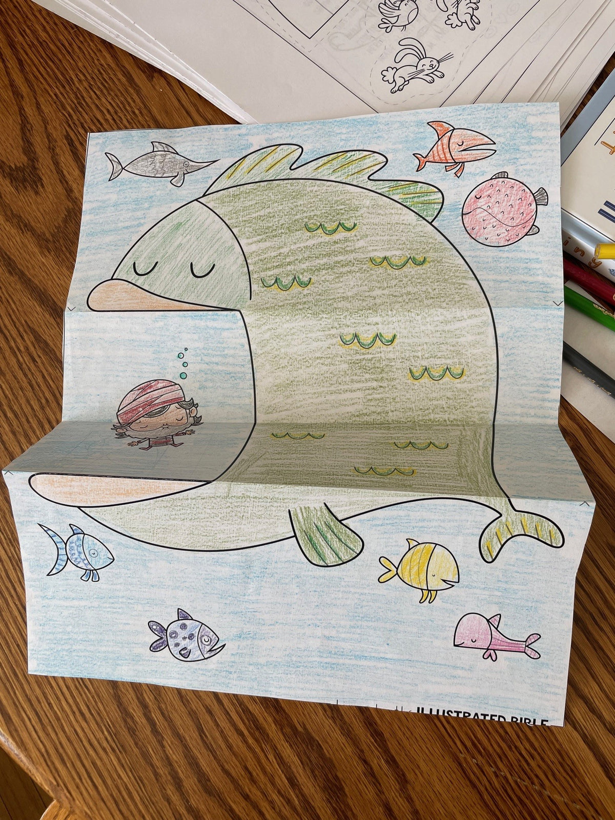 Wooden step stool with whale design on a wooden floor