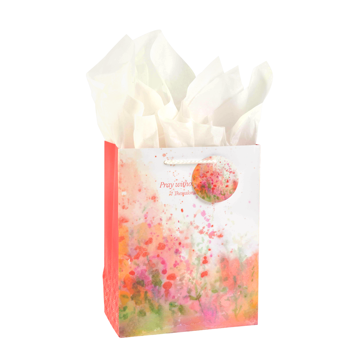 Gift bag with floral design and white tissue paper on a white background by CTA Christ to All and CTA Gifts.