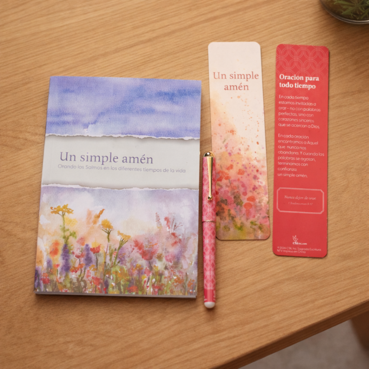 Notebook, pen, and bookmarks on a wooden surface by CTA Christ to All and CTA Gifts.
