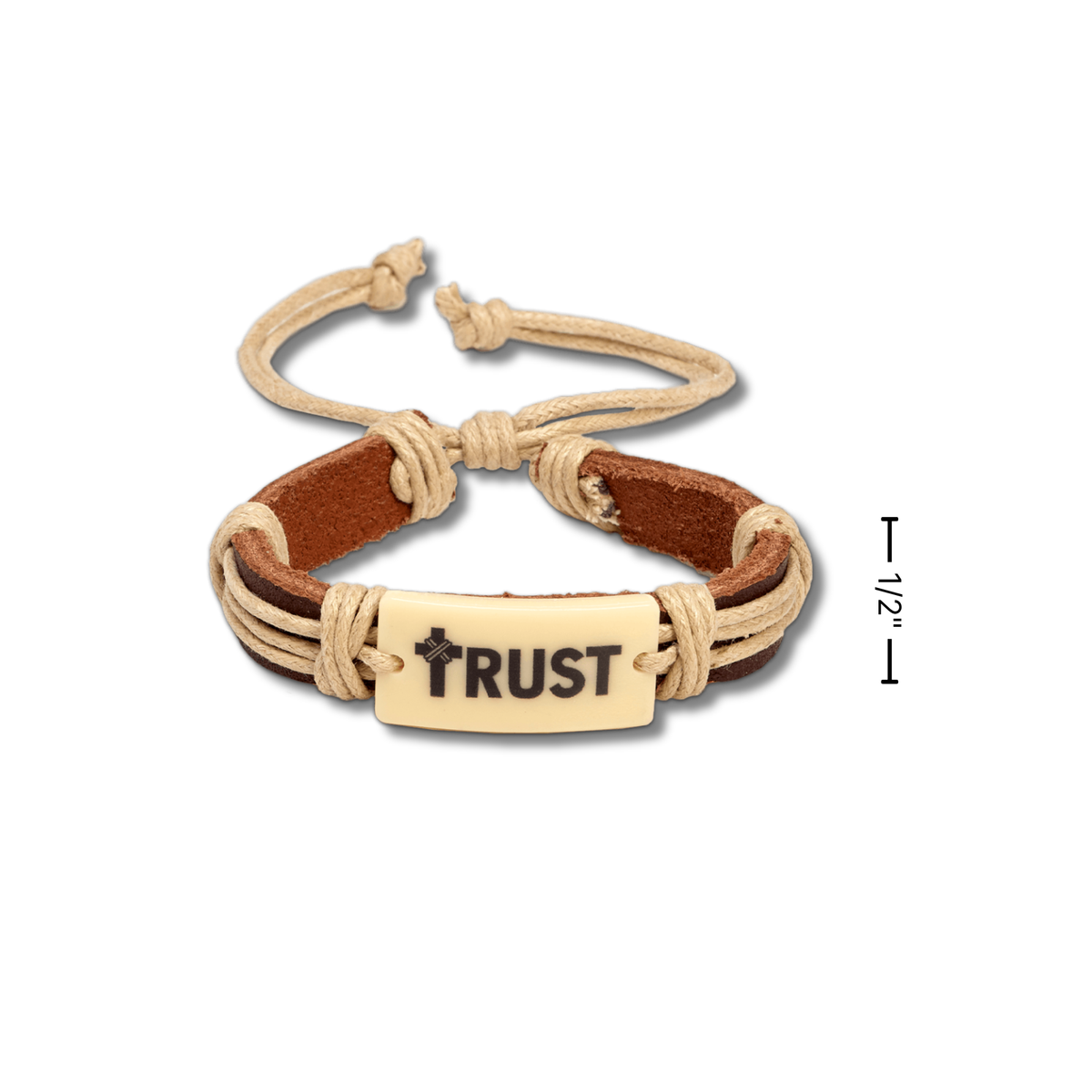 A cord and leather bracelet with a central cream-colored rectangular plate engraved with the word 'TRUST' and a small cross. A black measurement marker on the right indicates 1/2 inches by CTA Christ to All & CTAKids.