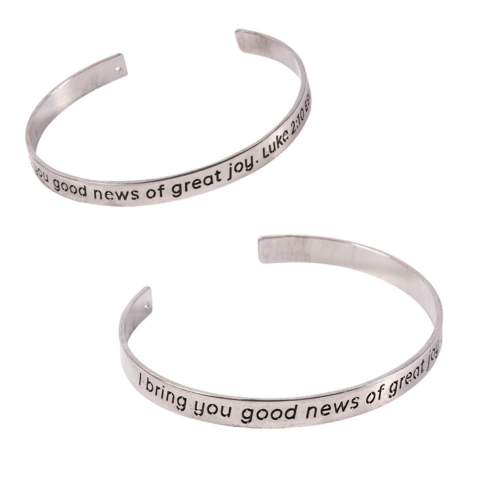 Thin silver-like bracket with Luke 2:10 engraved on it