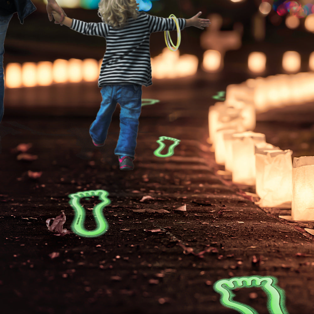 Glow in the Dark footprints with Bible verses on them on a candlelit path